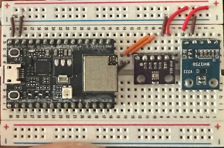 An ESP32-C3 board on a breadboard. The BMP280 and the BH1750 share one I2C
pair. The capacitive soil probe connects to an ADC1
pin.