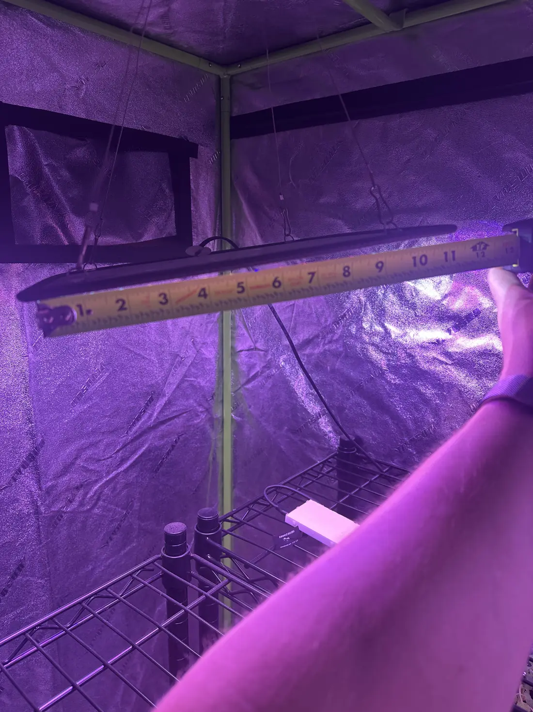 A tape measure held against the light bar to record its mounting height